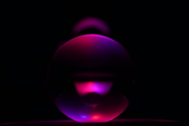 Black background with pink/purple bulb that blends into black background 